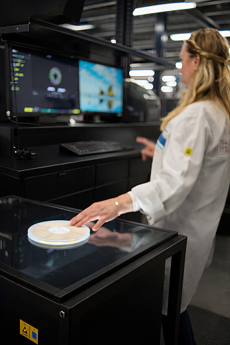 Frau scannt rundes Label mit Vision AI Label Reader ein.