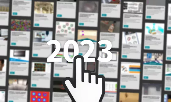 Eine symbolisierte Hand zeigt auf 2023 im Hintergrund sind verschwommen Kacheln mit Beiträgen zu sehen