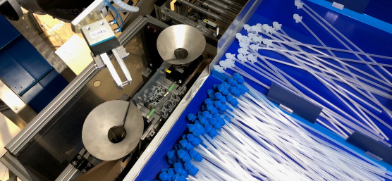 Ein Roboter sortiert mithilfe einer Ensenso 3D Kamera Katheder mit blauen und weißen Aufsätzen.