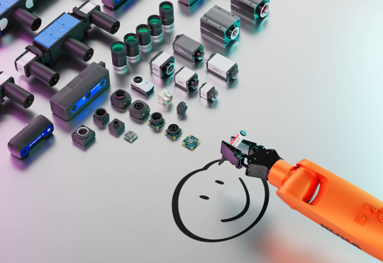 Kamerasortiment von IDS, davor Roboterarm, der einen Smiley zeichnet