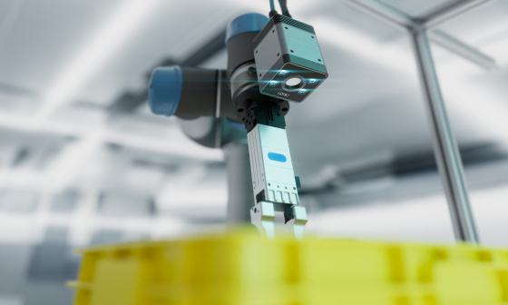 Roboterarm mit einer Nion 3D-Kamera über einer gelben Kiste