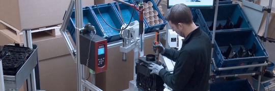 Produktionsmitarbeiter bei Prüfprozessen wird von KI assistiert.